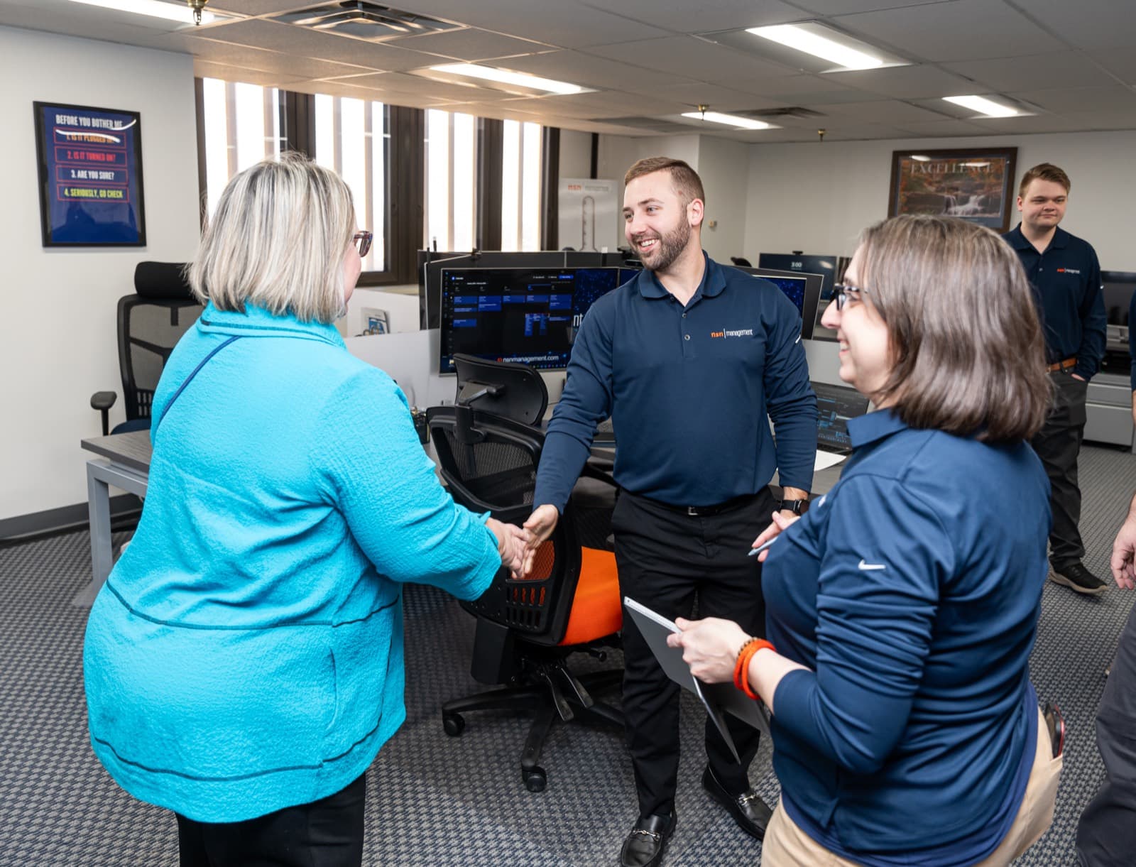 NSN Management team members welcoming a visitor at the Tulsa office