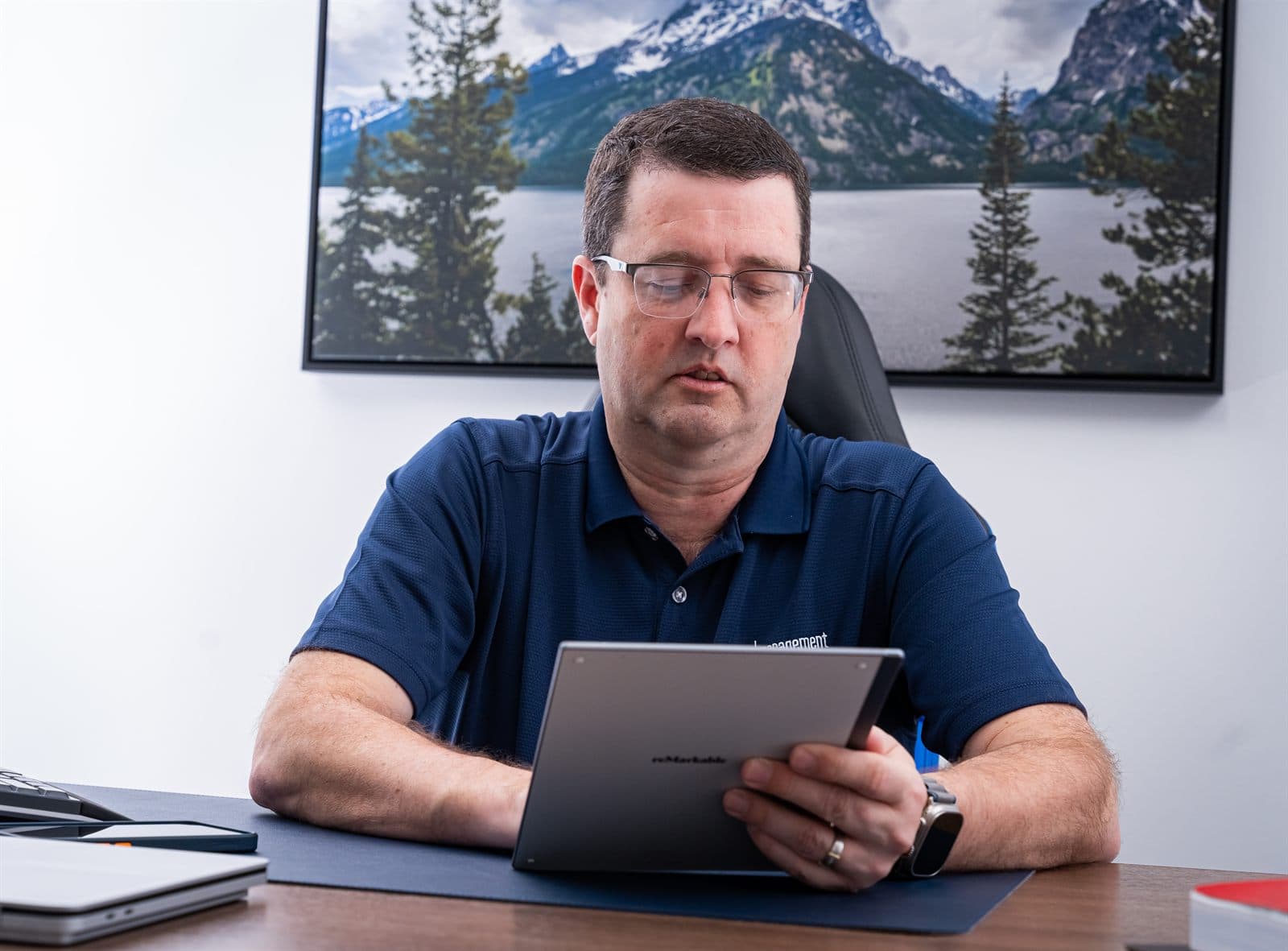 Sean Fullerton working from his desk at the NSN Management office in Tulsa